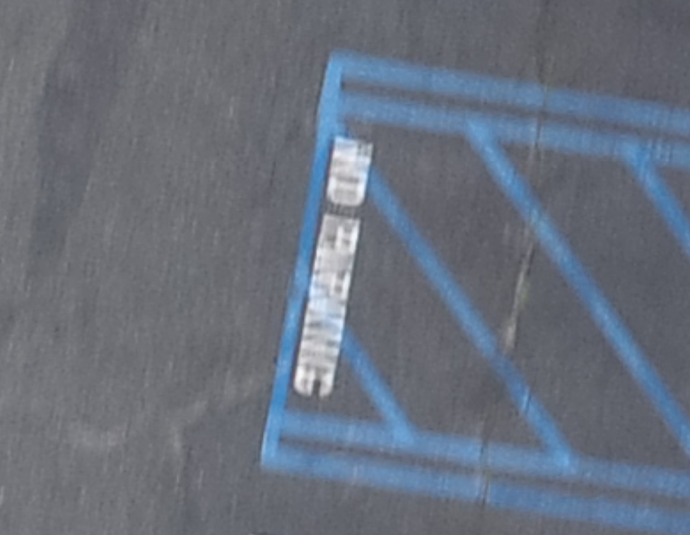 It is almost impossible to read this “no parking” paint due to the severe blurring.